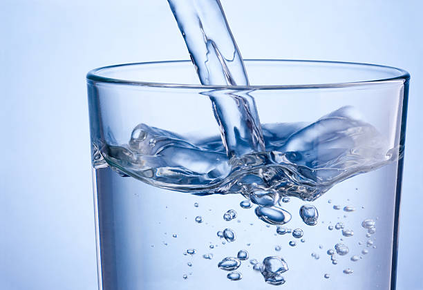 detox water being poured in a glass