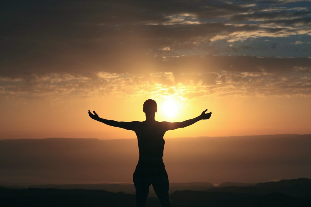 Person standing in the sun set